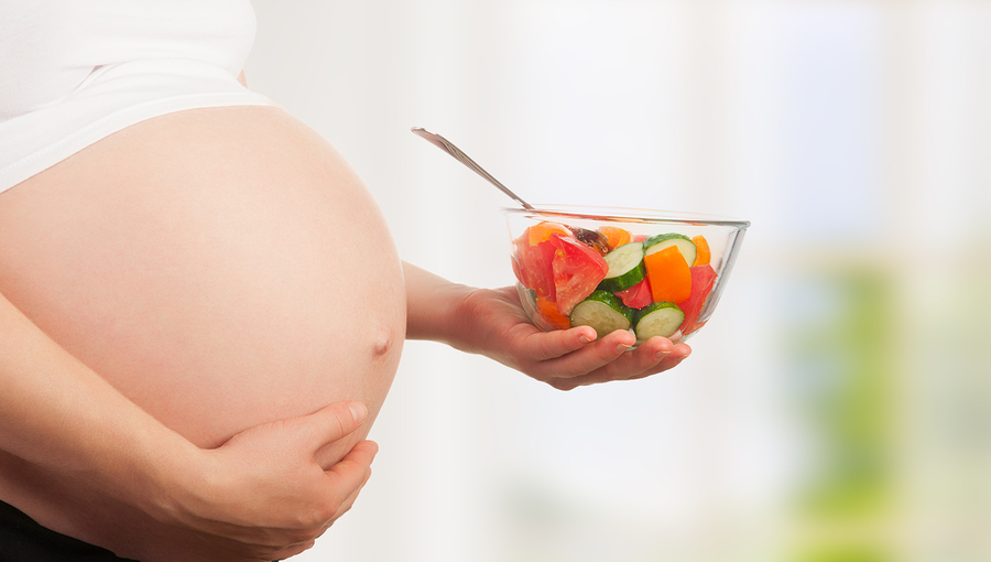 Healthy Nutrition And Pregnancy. Pregnant Woman And Vegetable Sa